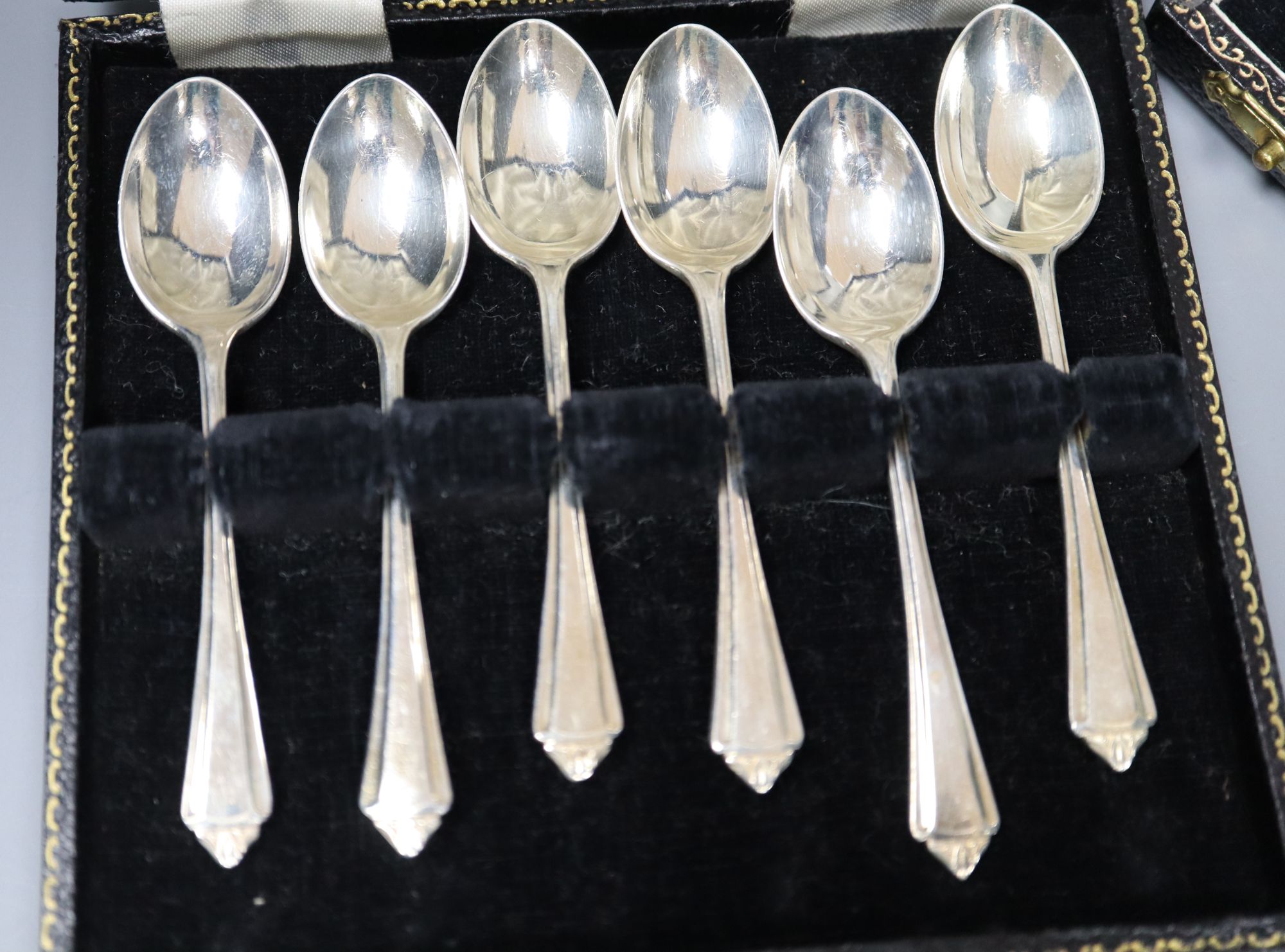 A cased set of six mid 20th century silver teaspoons and six similar coffee spoons.